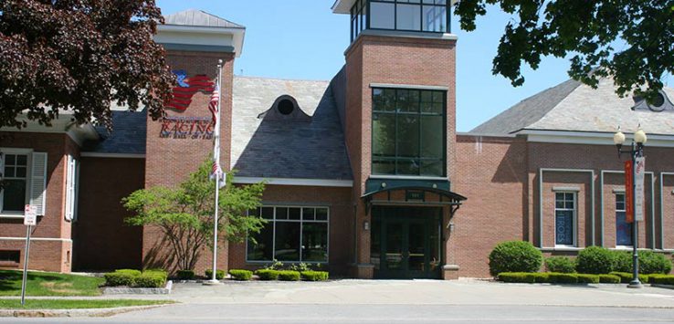 Street view of national racing hall of fame, a brick building with trees in front