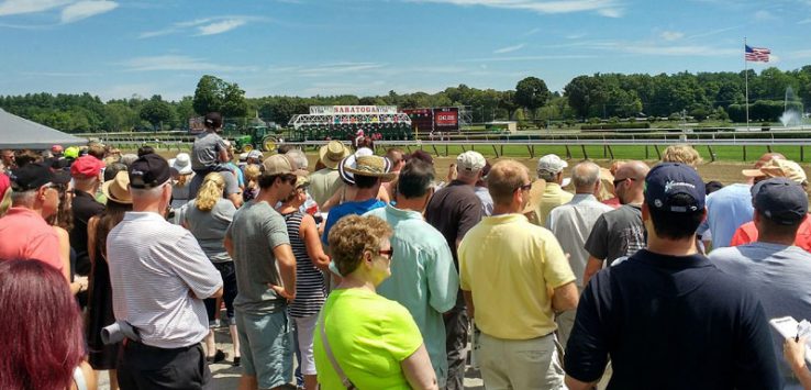 a crowd looks on at the race track