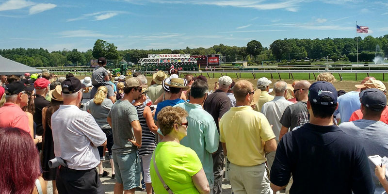 a crowd looks on at the race track