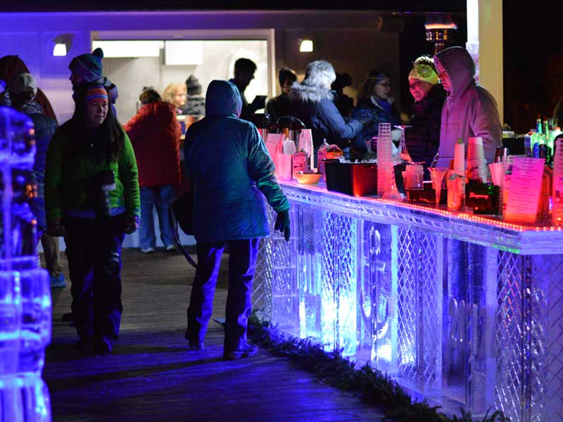 An ice bar filled with patrons in Lake George