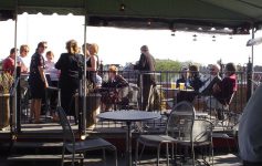 outdoor patio with people at Saratoga City Tavern