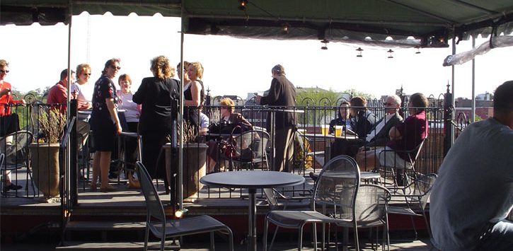 outdoor patio with people at Saratoga City Tavern