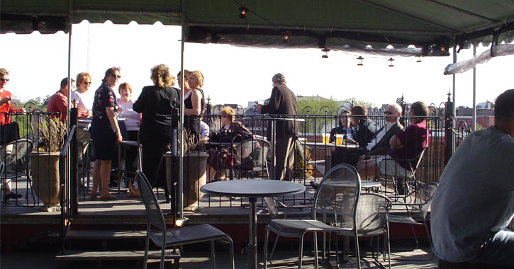 outdoor patio with people at Saratoga City Tavern