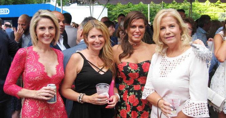 four women posing with cocktails