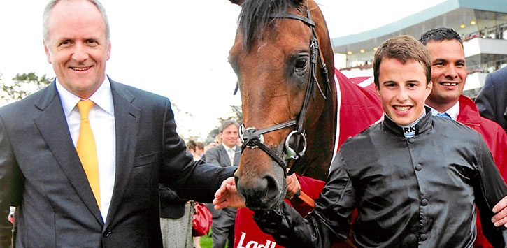 man and jockey near horse