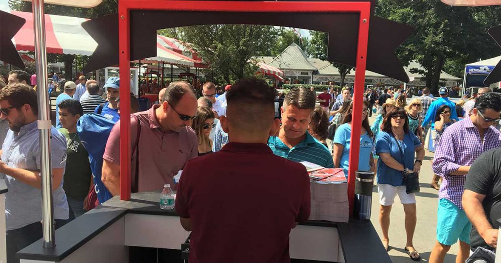 worker at booth at saratoga race course