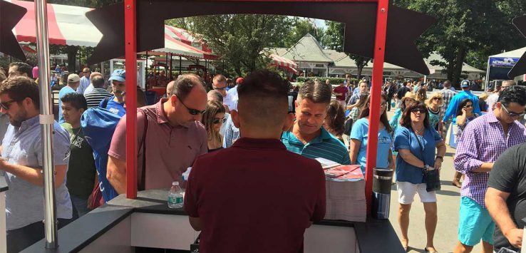 worker at booth at saratoga race course